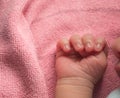 Close up newborn baby hand on pink blanket ,new family member sleeping with his mother look cutes.