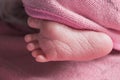 Close up newborn baby foot on pink blanket ,new family member sleeping with his mother look cutes.