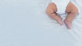 Close up of newborn boy legs on white sheet background. Baby sleeping on the bed Royalty Free Stock Photo