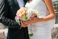 Close-up newlywed bride and groom hugging and holding wedding bouquet in hands, selective focus Royalty Free Stock Photo