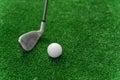 Close-up niblick and white ball for golf on the green grass. Empty right side for text of advert for golf clubs. Playing Royalty Free Stock Photo