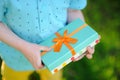 Close-up of nicely wrapped birthday gift being held by a child