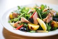 close-up on a nicoise salads tuna chunks with visible seasoning Royalty Free Stock Photo