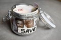 Close up Nigerian one thousand naira notes in savings jar