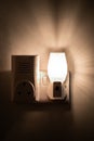 Close up of a night light plugged into a wall in a house Royalty Free Stock Photo