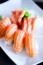 Close up of nigiri sushi with salmon fish on top of it