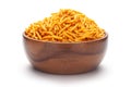 Close-up of Nimbu masala besan sev Indian namkeen snacks In hand-made handcrafted wooden bowl over white background