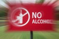 Close-up of the no alcohol sign in motion blur in the park near residential area