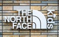 Close up of The North Face Kids logo on a brick wall