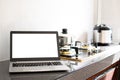 Close up, A notebook computer white screen and keyboard are blurred on the kitchen counter. Has a pot on the gas stove. Blurred Royalty Free Stock Photo