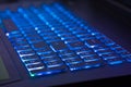 Close-up of notebook keyboard with blue light tint