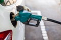 close up nozzle fuel fill oil into car tank at pump gas station Royalty Free Stock Photo