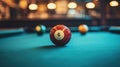 Close-up of a number 8 billiard ball on a pool table in a dimly lit bar Royalty Free Stock Photo