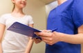 Close up of nurse with clipboard and pen with girl Royalty Free Stock Photo