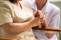 Nurse comforting female patient in the room