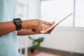 Close up of nurse or doctor entering patient information into digital tablet