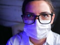 Close up of a nurse. Doctor nurse, behind the mask of a surgeon. Closeup portrait of a young caucasian woman model wearing black Royalty Free Stock Photo