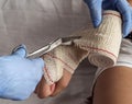 Close-up Of A Nurse Tying Bandage On Patient`s Foot Royalty Free Stock Photo