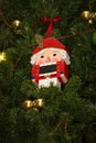 Close-up of nutcracker toy soldier christmas decoration hanging on the Christmas tree. Royalty Free Stock Photo