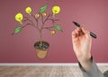 Hand holding pen and Drawing of Money and idea graphics on plant branches on wall