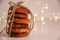 Close up of oatmeal cookies in a stack and tied with brown thread on bright background with bokeh. Sweet food concept with copy Royalty Free Stock Photo