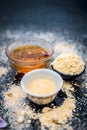 Close up of oats face pack i.e. Rose water,oats,gram flour and honey on wooden surface used in spa for smoother and cleaner skin.