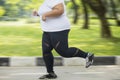 Obese woman feet sprinting on the road Royalty Free Stock Photo