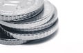 Close-up obverses of silver coins, stacked in uneven stack
