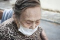 close-up of an octogenarian woman walking around in a wheelchair