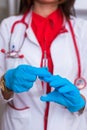 Close up of a female doctor  nurse  holding a syringe while standing in a medical office Royalty Free Stock Photo