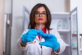 Close up of a female doctor  nurse  holding a syringe while standing in a medical office Royalty Free Stock Photo