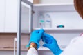 Close up of a female doctor  nurse  holding a syringe while standing in a medical office Royalty Free Stock Photo