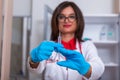 Close up od a female doctor  nurse  holding a syringe while standing in a medical office Royalty Free Stock Photo