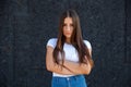 Close-up of an offended Caucasian girl crossing arms, looking at the camera Royalty Free Stock Photo