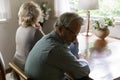 Close up offended mature man and woman ignoring each other