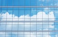 Close up of office building with reflection of blue sky and cloud. Business background. Royalty Free Stock Photo