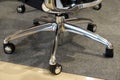 Close up of office chair wheels on the floor in the office. metal legs.