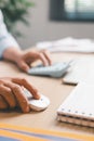 Close-up of office worker using computer mouse while working at desk, illustrating digital tasks, productivity, online work, Royalty Free Stock Photo