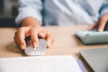 Close-up of office worker using computer mouse while working at desk, illustrating digital tasks, productivity, online work, Royalty Free Stock Photo