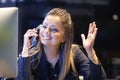 Young woman sitting at her desk working and answering a phone call. Royalty Free Stock Photo