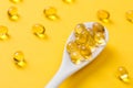 Close up of oil filled capsules on spoon suitable for: fish oil, omega 3, omega 6, omega 9, vitamin A, vitamin D, vitamin D3,