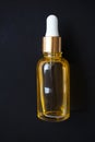 Close-up Oil serum essence in glass bottle on black