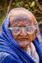 Close up of old aged poor lady bagging in front of mosque Royalty Free Stock Photo