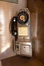 Close Up of Old Antique Rotary Pay Phone in Phone Booth