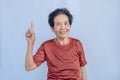 Close-up of old Asian woman face with wrinkles elderly senior and smiling happiness with a few broken teeth looking at the camera Royalty Free Stock Photo