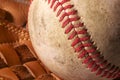 Close up of an old baseball in a mitt. Royalty Free Stock Photo