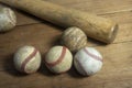 Close up old baseball and wooden baseball bat on a woodeb table. select focus. Royalty Free Stock Photo
