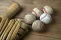 Close up old baseball, wooden baseball bat and baseball glove on a woodeb table. select focus. Royalty Free Stock Photo