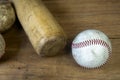 Close up old baseball and wooden baseball bat on a woodeb table. select focus. Royalty Free Stock Photo