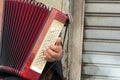 Close Up of Old Beggar Woman Playng a Dirty Accordion in the Street